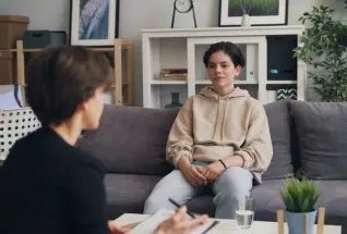 A person attending an individual therapy session with their therapist