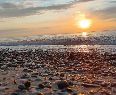 Cinematic shot of Lake Erie with a sunset in the background.