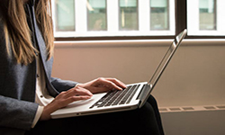 Woman using a laptop to check her insurance coverage