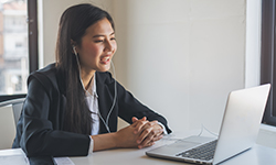 Woman using a laptop to match with a therapist