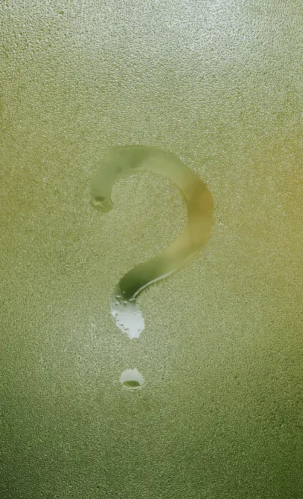 Large question mark carved or formed in textured sand or concrete surface, representing questions about depression therapy and treatment options