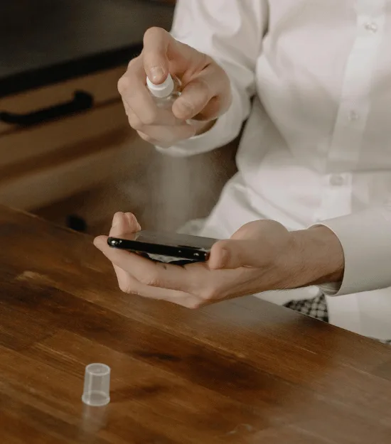 Hands applying hand sanitizer from pump bottle, representing compulsive cleaning behaviors and fear of contamination common in OCD